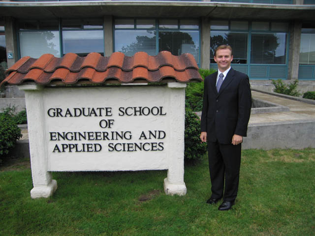 Ben in front of NPS grad sign